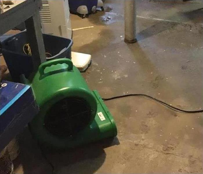 One of our air movers drying the floor of this home after a flood