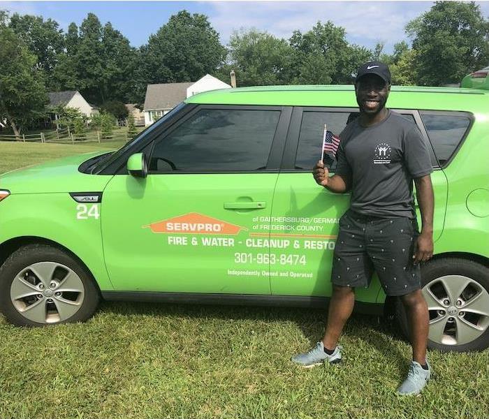 male standing by a SERVPRO car