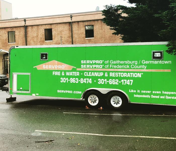 green large SERVPRO trailer at a job site